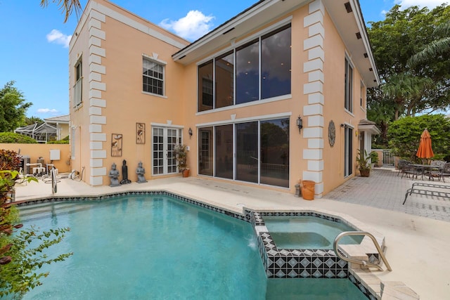 view of pool with an in ground hot tub and a patio