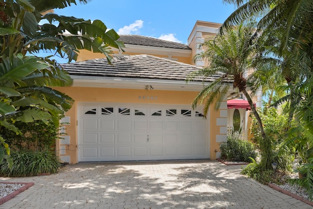 garage with decorative driveway