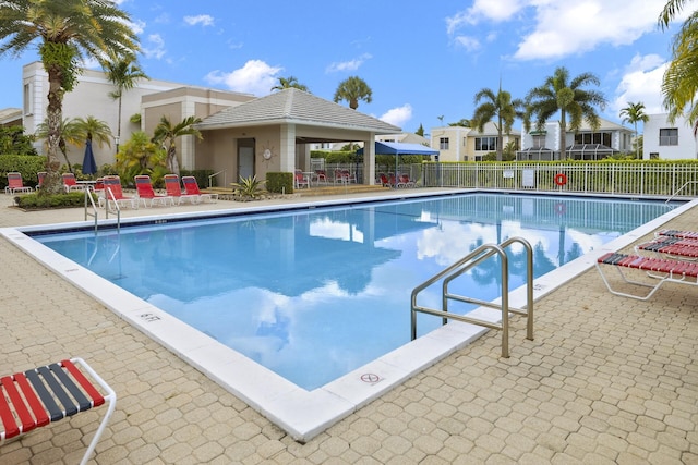 community pool featuring a patio area, fence, and a gazebo