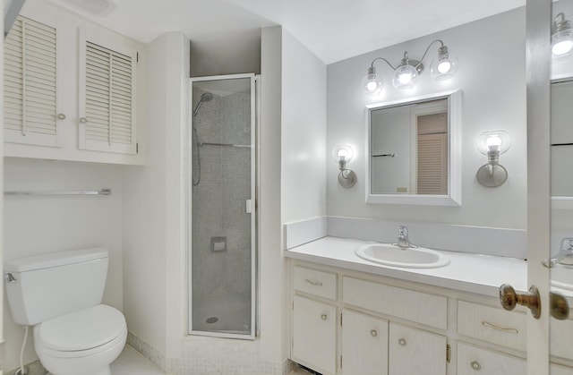 bathroom with a shower with door, vanity, and toilet