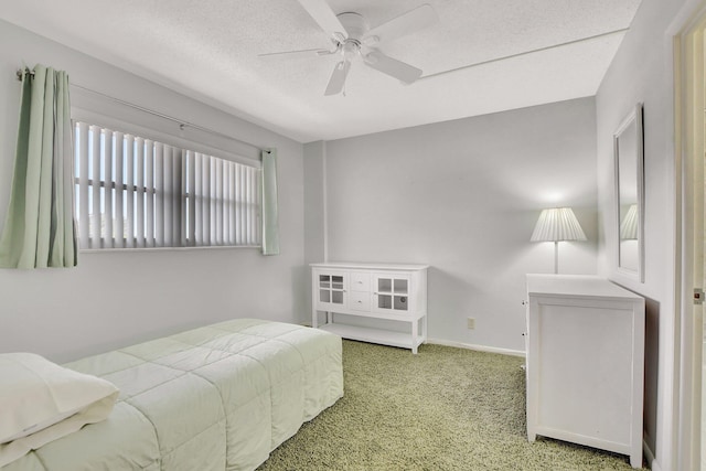 bedroom with a textured ceiling, carpet, and ceiling fan