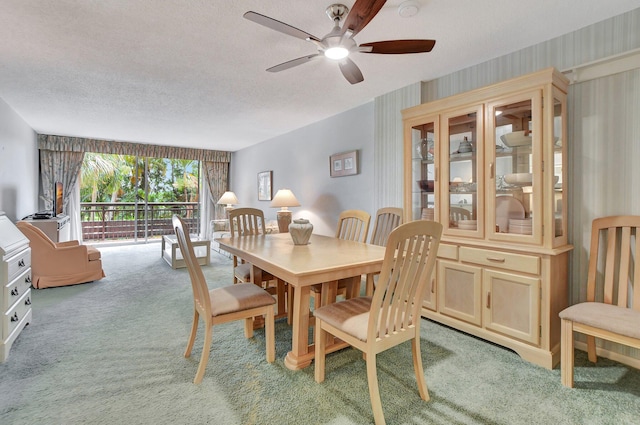 dining area featuring a textured ceiling, ceiling fan, and carpet floors