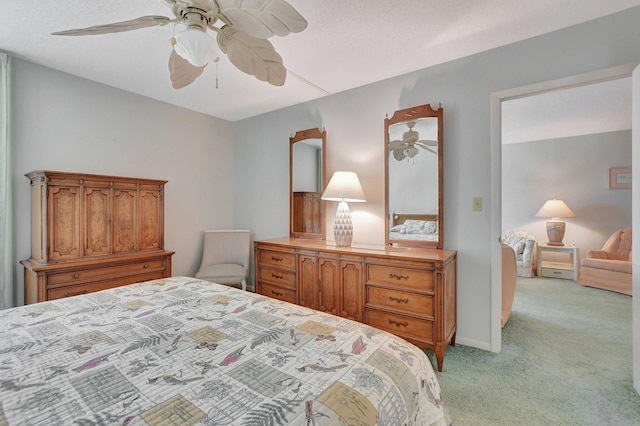 bedroom with ceiling fan and light carpet