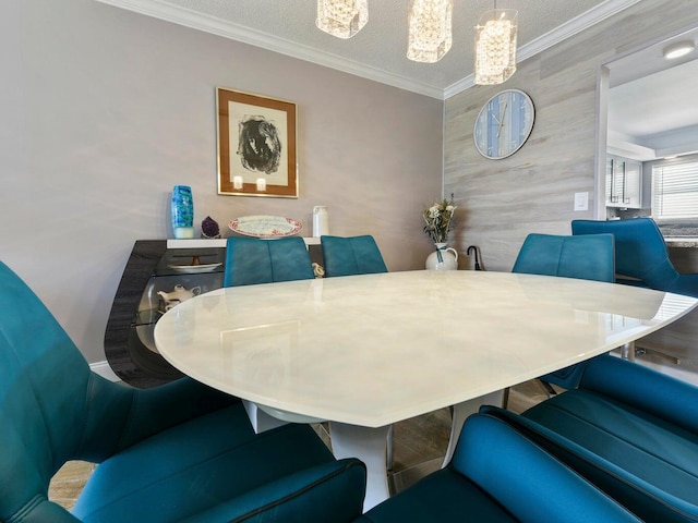 dining area featuring a notable chandelier, a textured ceiling, and crown molding