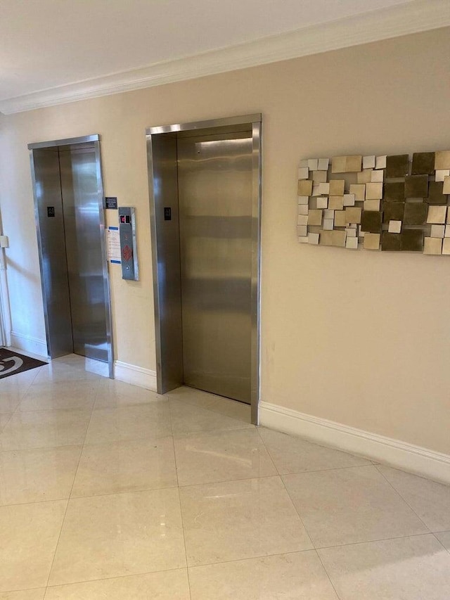 hall with light tile patterned floors, crown molding, and elevator