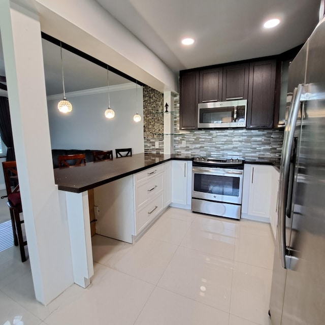 kitchen featuring stainless steel appliances, hanging light fixtures, decorative backsplash, light tile patterned flooring, and kitchen peninsula