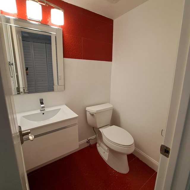 bathroom with tile patterned floors, vanity, and toilet