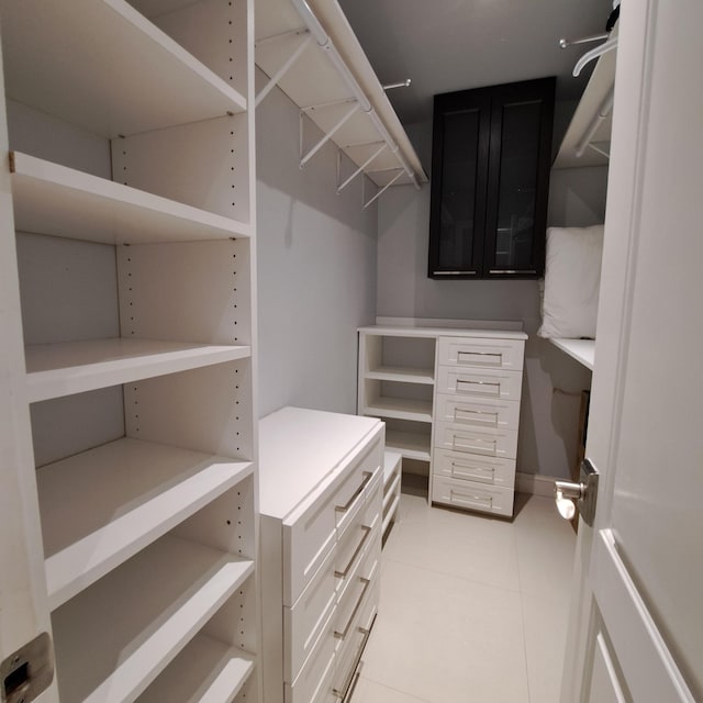 walk in closet featuring light tile patterned flooring