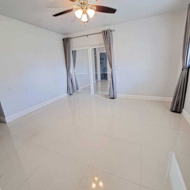 unfurnished room featuring ceiling fan and light tile patterned flooring