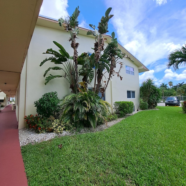 view of side of property with a lawn