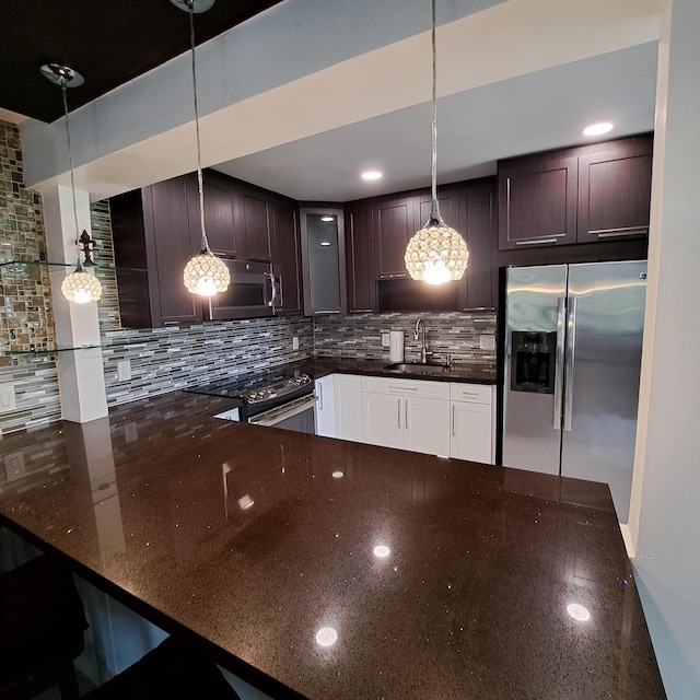 kitchen with pendant lighting, stainless steel appliances, backsplash, sink, and dark brown cabinetry