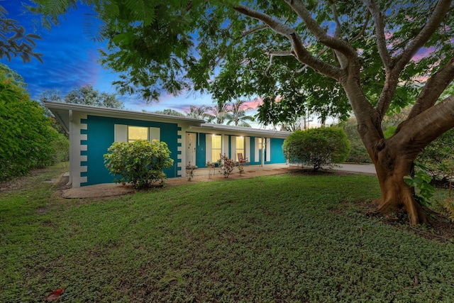 ranch-style house with a lawn