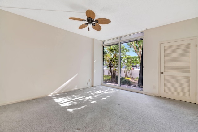 unfurnished room featuring ceiling fan and carpet flooring