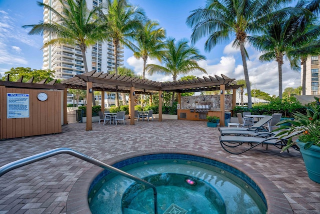 view of pool with a community hot tub, a patio area, and a pergola