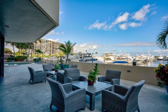 view of patio / terrace featuring an outdoor living space, a water view, and a fenced in pool