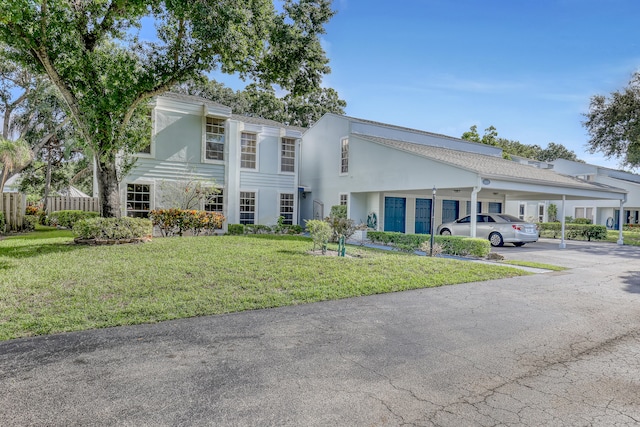 view of front of property with a front lawn and a carport