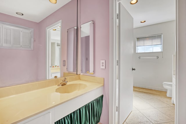 bathroom with vanity, tile patterned flooring, and toilet