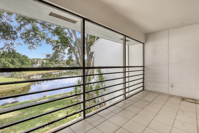 unfurnished sunroom with a water view