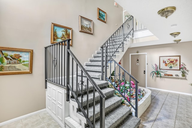 stairway with tile patterned floors