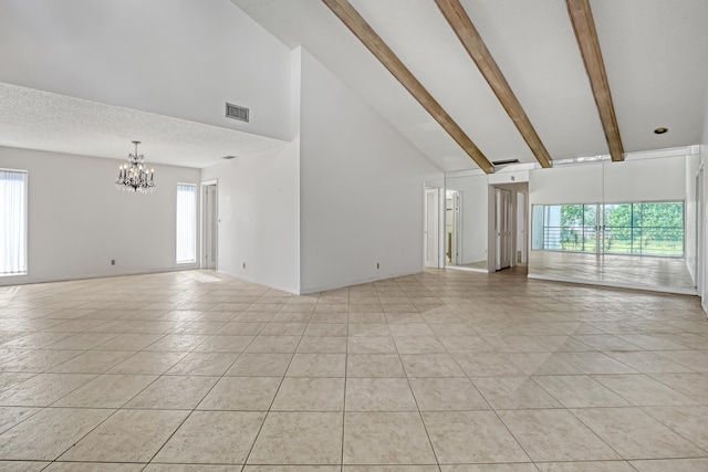 unfurnished living room featuring light tile patterned floors, high vaulted ceiling, a healthy amount of sunlight, beam ceiling, and a chandelier