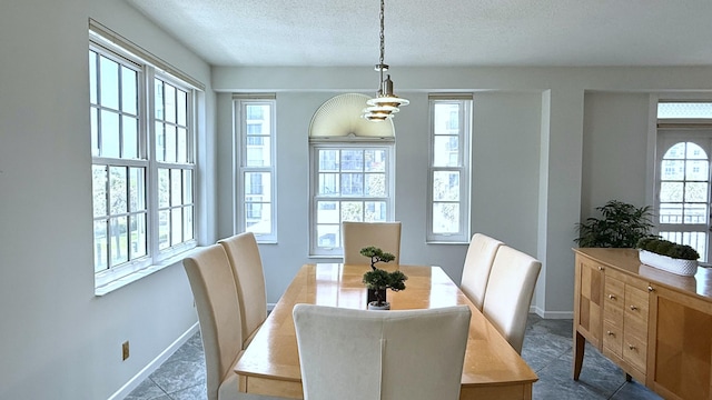 3475 S Ocean Blvd Unit 2160, Palm Beach, FL 33480 - dining area with baseboards, a textured ceiling, and dark tile patterned floors