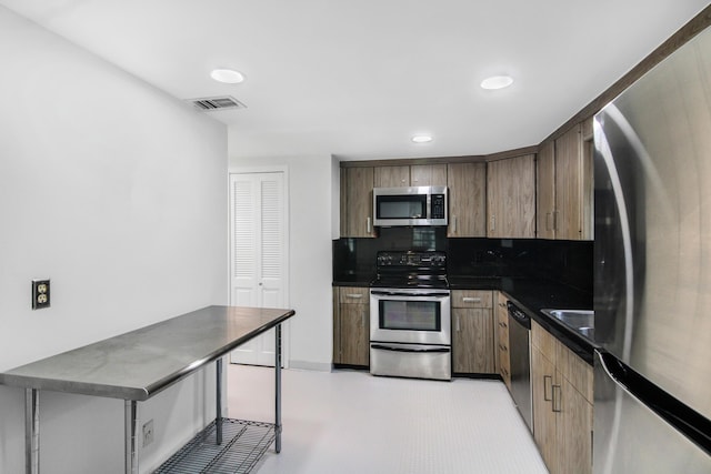 3475 S Ocean Blvd Unit 2160, Palm Beach, FL 33480 - kitchen featuring stainless steel appliances, dark countertops, recessed lighting, and tasteful backsplash