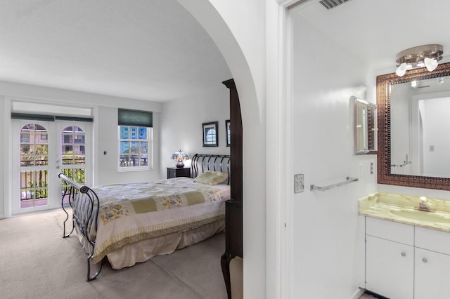 3475 S Ocean Blvd Unit 2160, Palm Beach, FL 33480 - bedroom featuring a sink, access to exterior, light carpet, and arched walkways