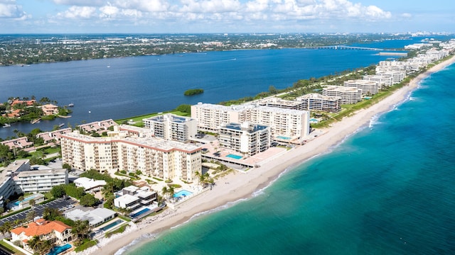 drone / aerial view with a view of the beach, a water view, and a city view