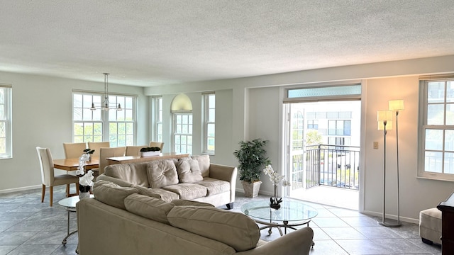 3475 S Ocean Blvd Unit 2160, Palm Beach, FL 33480 - living area with baseboards, a chandelier, and a textured ceiling