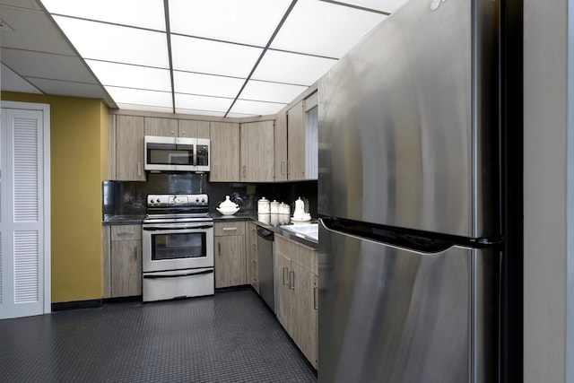 kitchen with stainless steel appliances, tasteful backsplash, dark countertops, and light brown cabinetry