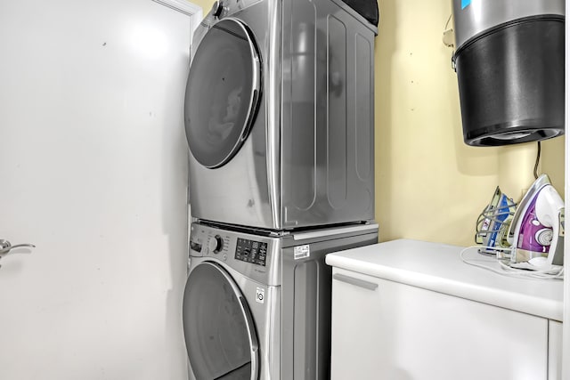 laundry area featuring laundry area and stacked washer / drying machine