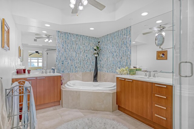 bathroom with two vanities, a stall shower, a sink, tile patterned floors, and a bath