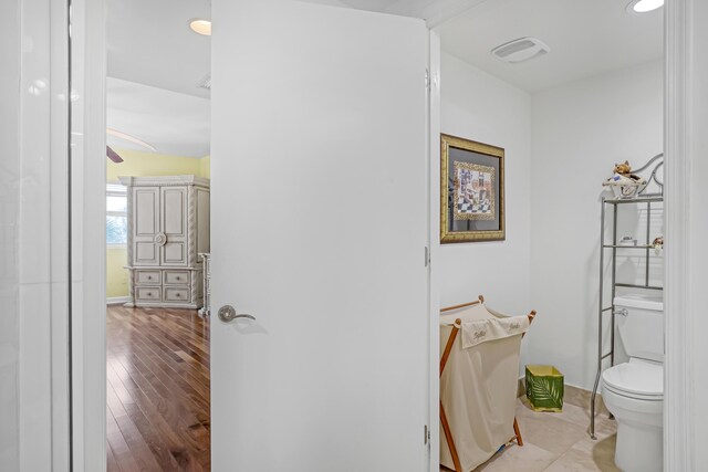 bathroom featuring toilet and wood finished floors