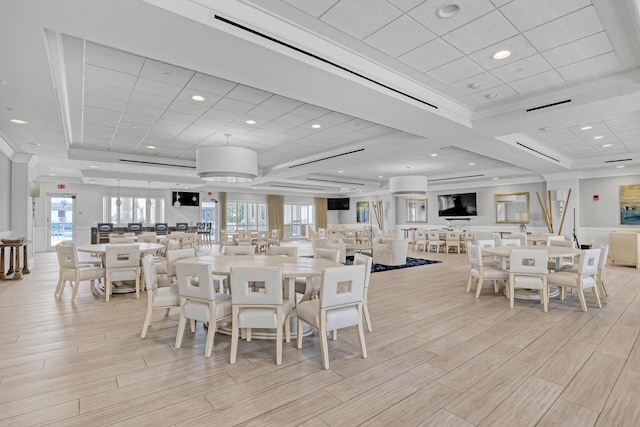 dining area featuring wood finish floors, visible vents, and plenty of natural light