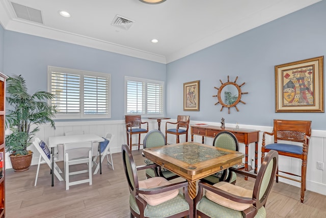 dining room featuring a wainscoted wall, light wood-style flooring, and visible vents