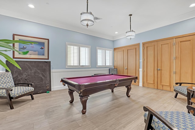 rec room featuring billiards, light wood finished floors, recessed lighting, wainscoting, and crown molding