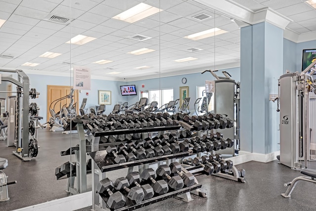 exercise room featuring visible vents, crown molding, and a drop ceiling