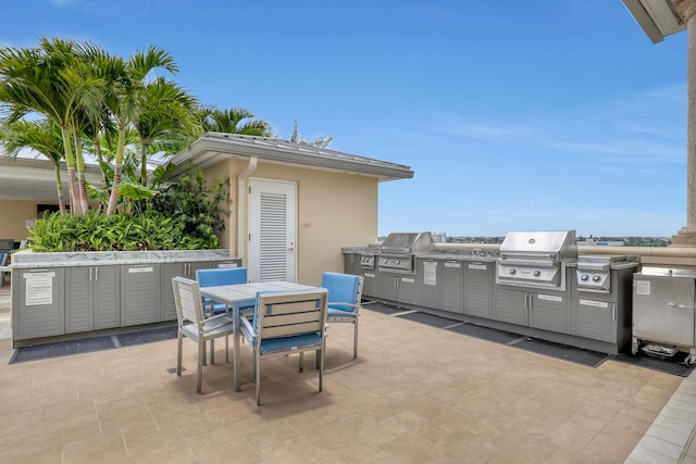 view of patio / terrace featuring an outdoor kitchen, a grill, and outdoor dining area