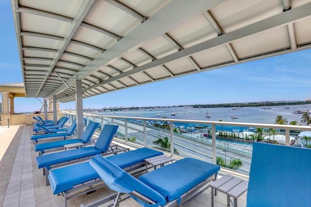 view of patio / terrace with a balcony and a water view