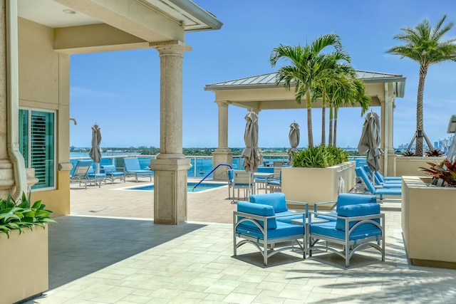 view of patio featuring a pool and a gazebo