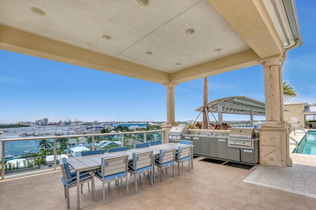 view of patio with a sink, grilling area, outdoor dining area, and exterior kitchen