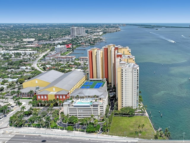 birds eye view of property with a water view and a city view