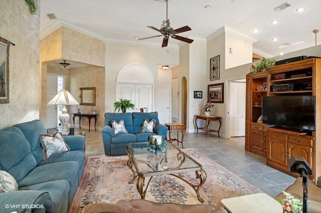 tiled living room with ceiling fan, a high ceiling, and crown molding