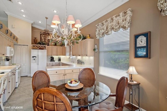 tiled dining space featuring sink, crown molding, and a chandelier