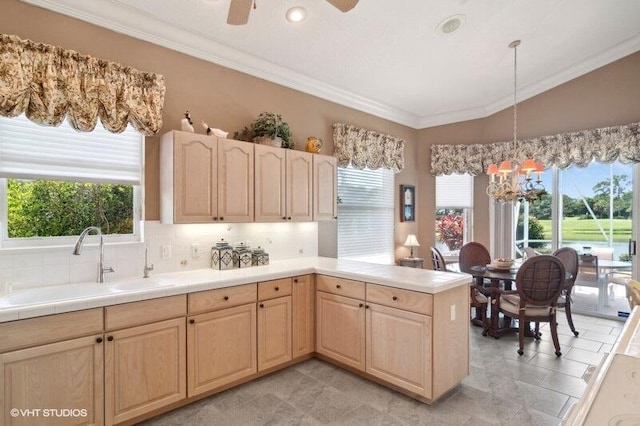 kitchen featuring backsplash, ceiling fan with notable chandelier, light tile patterned floors, and a healthy amount of sunlight