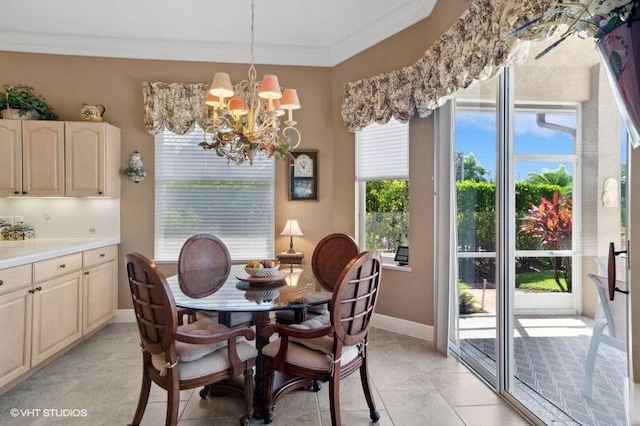 tiled dining space featuring a notable chandelier and ornamental molding