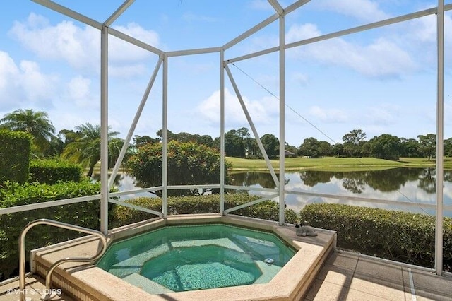 view of swimming pool featuring an in ground hot tub and a water view