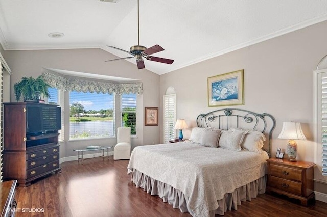 bedroom featuring ceiling fan, vaulted ceiling, dark wood-type flooring, and ornamental molding