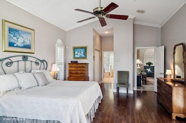 bedroom with ceiling fan, dark wood-type flooring, ornamental molding, and connected bathroom