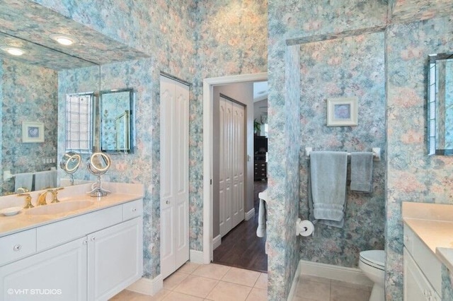 bathroom featuring tile patterned floors, vanity, and toilet